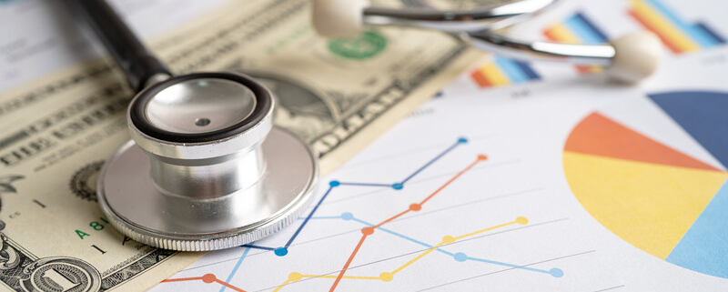 stethoscope with graphs and currency_canstockphoto100865763 800x533