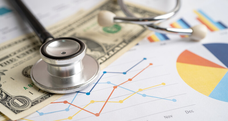 stethoscope with graphs and currency_canstockphoto100865763 800x533