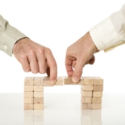 businessmen holding blocks_canstockphoto32110851 800x533