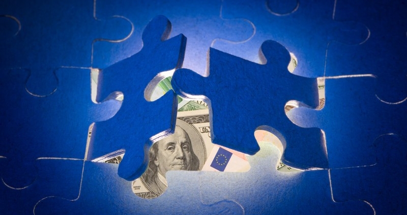 puzzle pieces with currency underneath_canstockphoto4886439 800x533