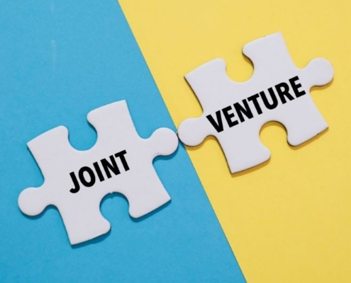 joint venture graphic_JOINT VENTURE word alphabet letters on puzzle_shutterstock_2500442725 800x533